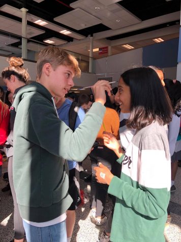 Freshman Jean Lavigne Du Cadet paints freshman Nirja Divekar’s face during NAHS’s face painting event in Nobel Commons during JLC. 