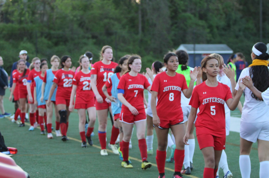 After playing, Jefferson girls junior varsity soccer team giving high fives to Justice junior varsity girls after a game. “I’m so glad I got to have this experience and play with my friends,”  Berhe said. 