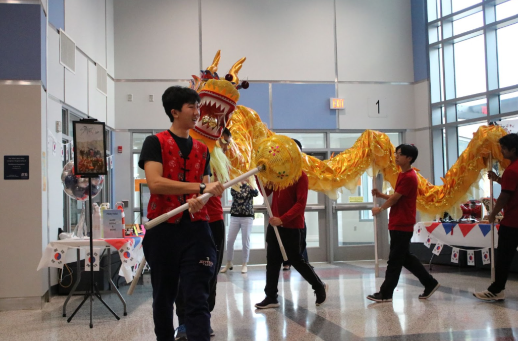 Senior Tommy Chen leads a dragon dance performance in Nobel Commons. The large entry space supported the Lunar New Year Celebration held by the PTSA Diversity Committee on February 2. “As far as the building supports school events, people attending these school events learn about new cultures,” sophomore Austen Ji said.