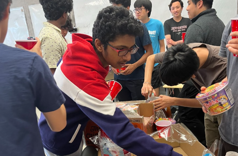 Reaching for a package of ramen, freshman Dhanvin Ganeshkumar focuses on cooking it and making it ready to eat. The ramen had to be prepared with warm water and spice packets in order to enrich the taste of the ramen. “The celebration was a blast spending quality time with friends and having great food,” Ganeshkumar said.