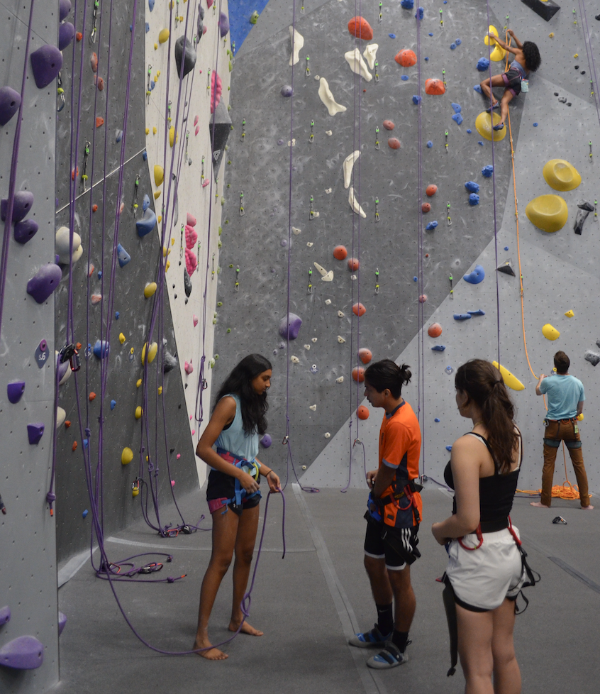 Founder and junior Aanya Gupta helps senior Isaias Garcia-Umana with his harness. Gupta began rock climbing at a young age with her aunt and uncle. “One day, when I was in seventh or eighth grade, my mom [was like], ‘Do you want to sign up for the team?’ Eventually I said, ‘Yeah, and then I climbed up on the team for a little bit, and then I started climbing outdoors a little bit, yeah.” 