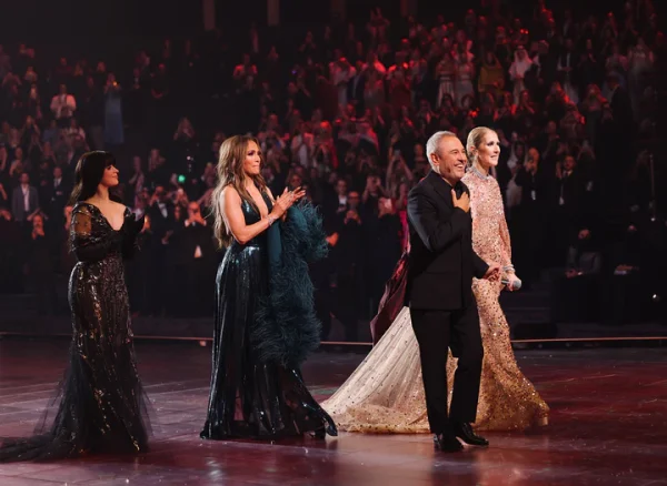 Elie Saab gets on stage after the event with Celine Dion, Jennifer Lopez and Camilla Cabello to wave to the audience.