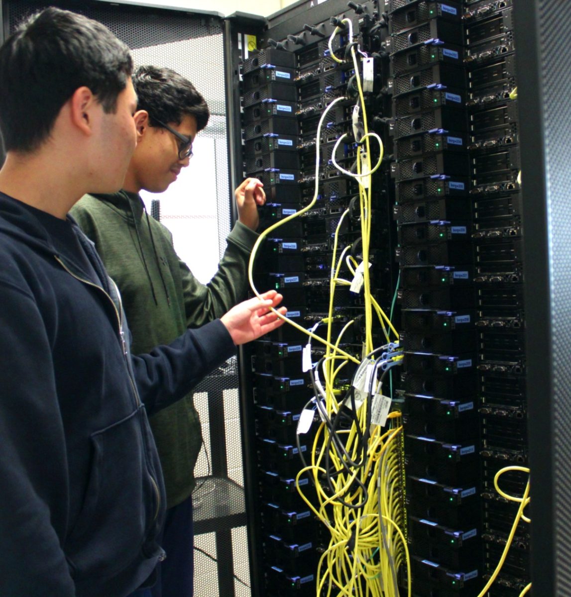 One of the server racks are inspected by senior lead Sysadmins Alan Zhu and Sami Elsayed inside Jefferson’s server room in the Computer Systems Lab. “We have multiple servers in our lab. We have one massive cluster that has over 40 nodes,” Elsayed said. “It’s made for students who are in Computer Vision and can’t run code on their laptops.”