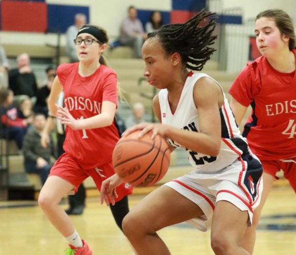 Junior Abeni Smith dribbles the basketball, desperate to score a point for her and her team. “I was really determined to play my part to help my team win,” Smith said. “So I think [there] was just determination going through my head.”