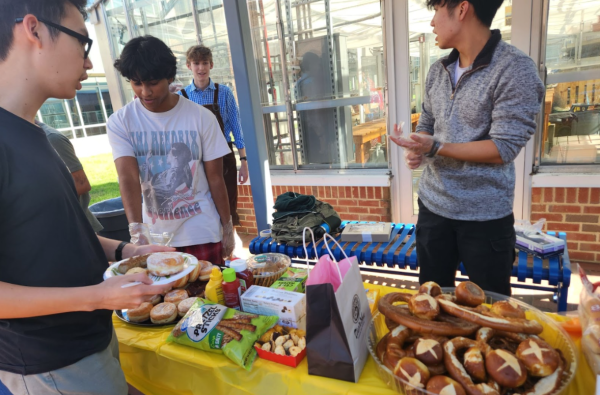 Junior Irmuun Bayart-Od accepts food at the start of German Honor Society's annual Oktoberfest celebration on Friday, Oct. 18. "A big part of the Oktoberfest celebration is the food,” senior treasurer Sumedh Anuganti said. “We bring a lot of food, [but[ we always go a little overboard on the sweets.”