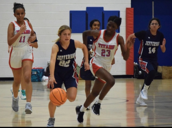 Jackie Pritcahrd dribbles the basketball down the court. “Jackie scored 15 [points],” freshman Amrutha Somireddy said. “ It was a great game.”