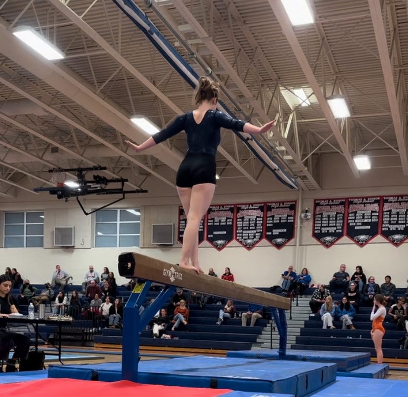 Sophomore Aerin Bernstein completes her beam routine at the meet. “[This was] a routine I’ve done since last year, but I changed to make it better this year,” Bernstein said. “I ended up scoring a 6.75, which was my new high score.”