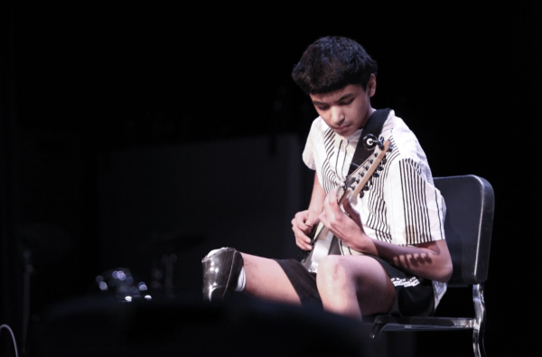 Strumming his guitar, sophomore Jeevan Vakati plays “There’s Nothing Holding Me Back” by Shawn Mendes for the TJ 2025 Talent Show.