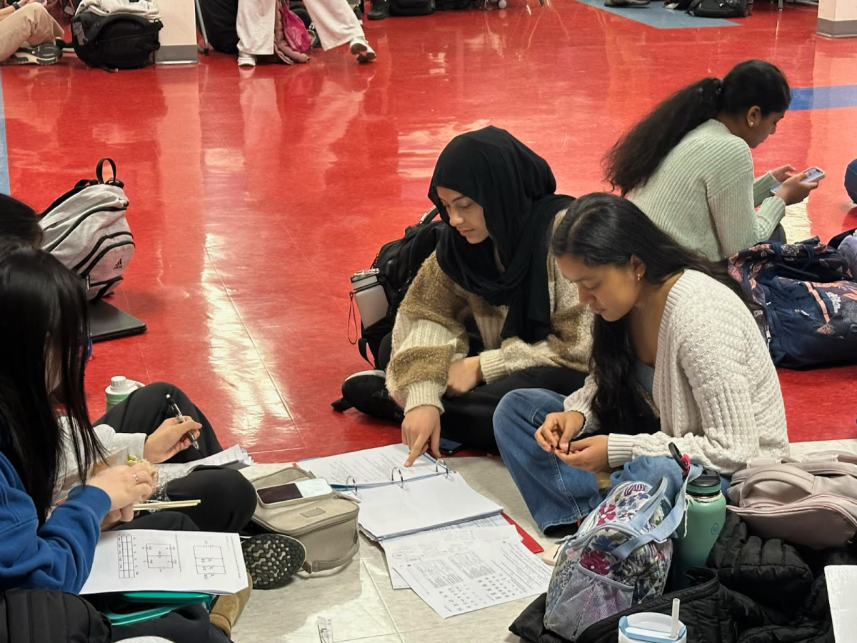 Students review work from their design and tech class in Turing Commons during lunch. 