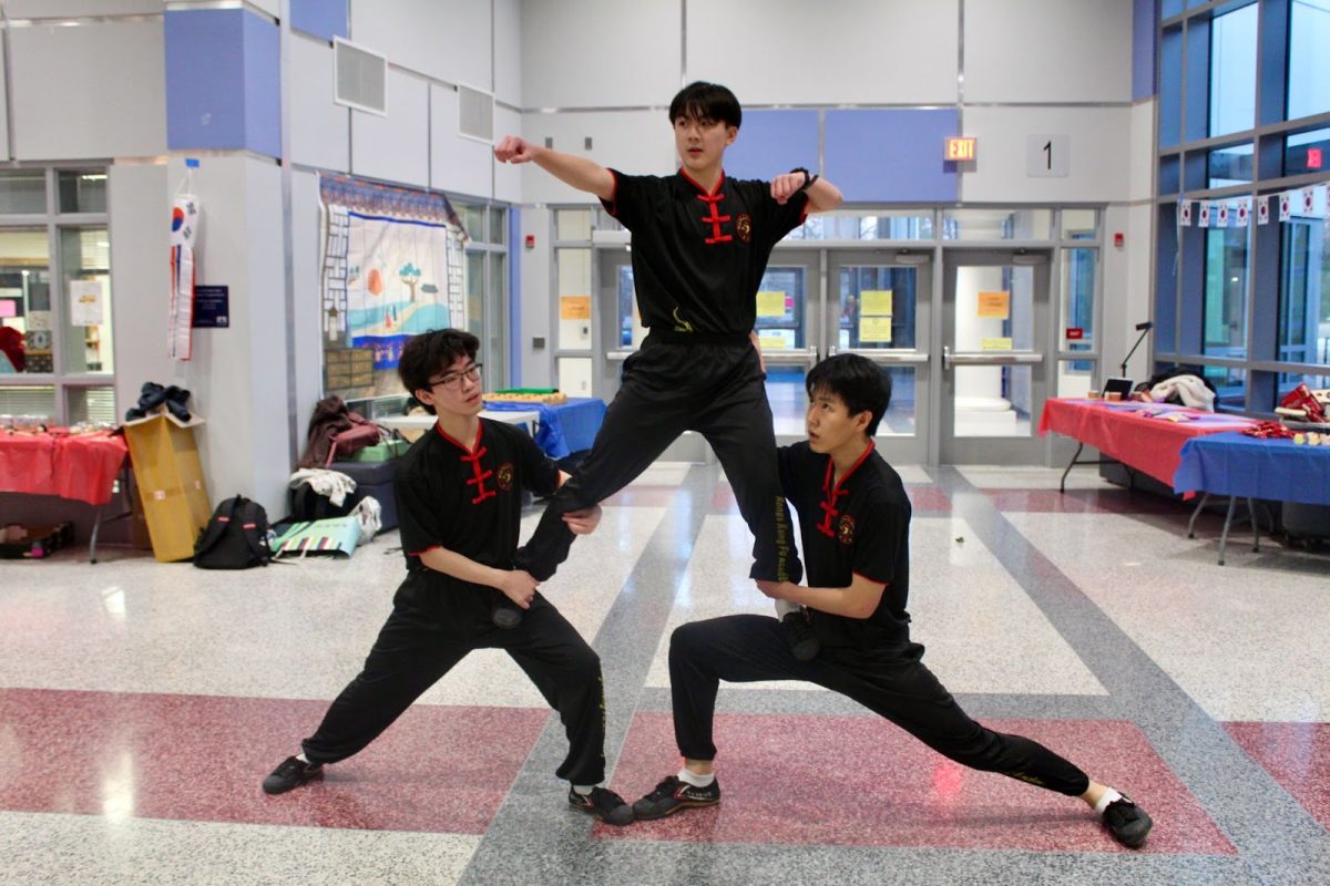 Freshman Zachary Qin, junior Yihao Wang and freshman Patrick Zhao demonstrate Wushu dance. “It’s the start of a new year and it’s part of my culture, so it’s pretty important,” Zhao said. 